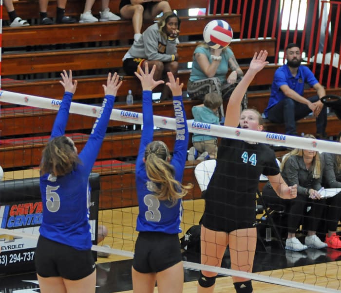 Jensen Beach senior Lindsay Walch (44) tries to tip over Barron Collier's Charlotte Mongin (5) and Chloe Goldenbaum during their Class 5A volleyball final. Walch had 16 kills.